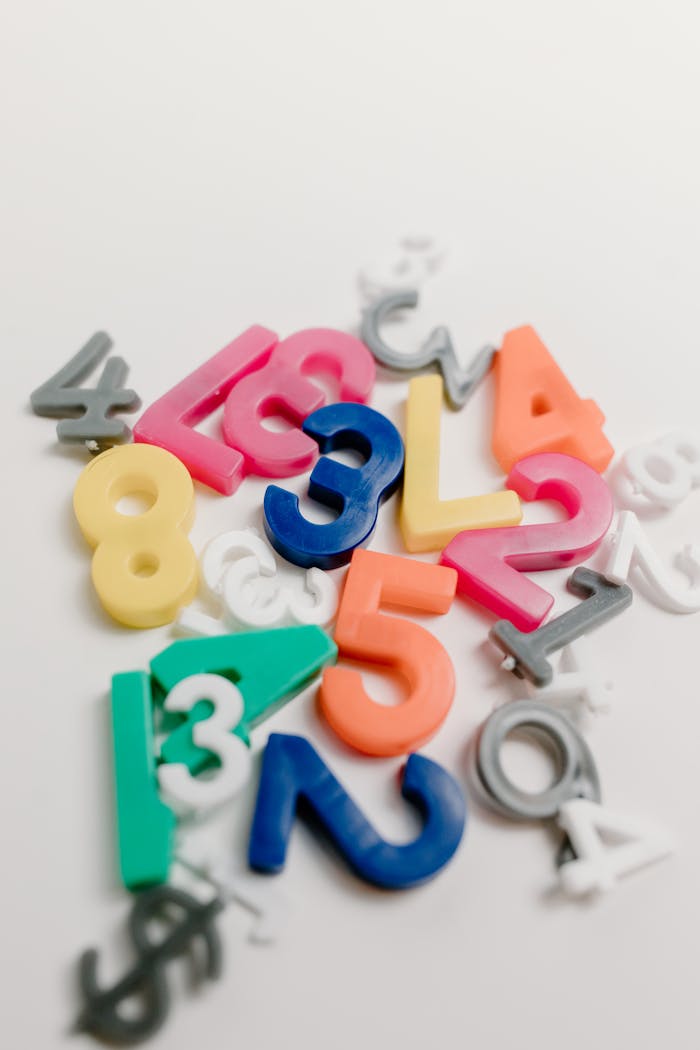 hero-services Vibrant plastic numbers scattered on a white background, ideal for educational themes.