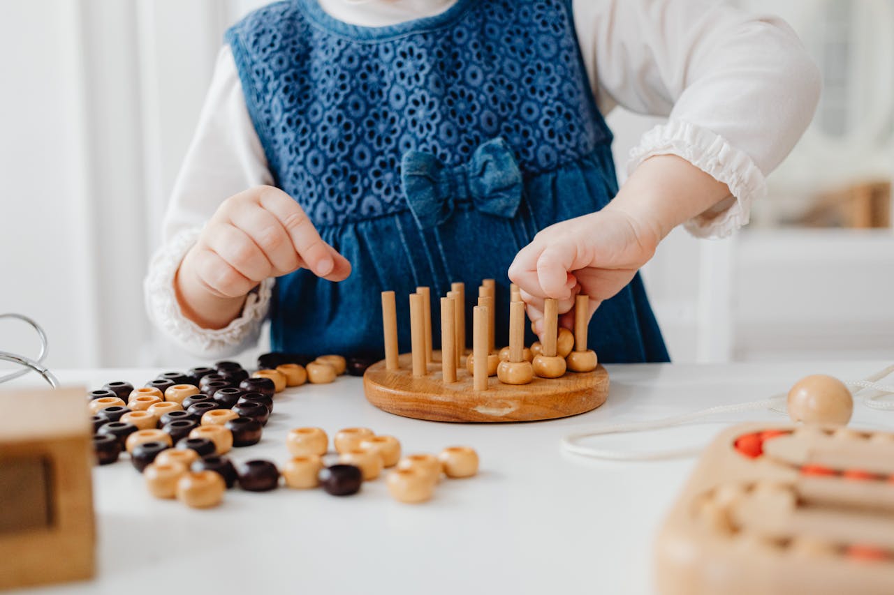 approach-img A child interacts with a wooden sorting toy, developing fine motor skills and learning through play.