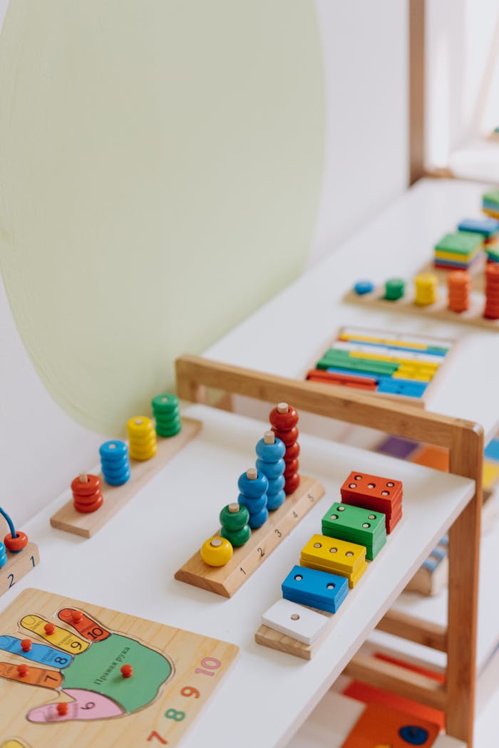 hero-about Bright and colorful educational wooden toys displayed on a table in a classroom.